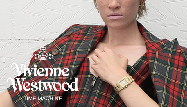 Model wearing Vivienne Westwood unisex watch with red dial and gold bracelet, showcasing bold, fashion-forward style.